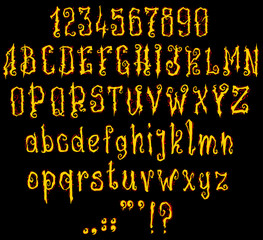 Handrawn curly yellow fire font. Gothic style. Vector alphabet, numbers and symbols. Isolated on black background.