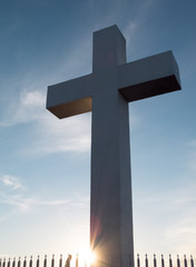 Starburst sun burst at sunset on a large cross in San Diego