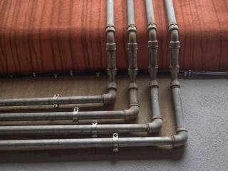 pipes and fittings follow the wall of a building