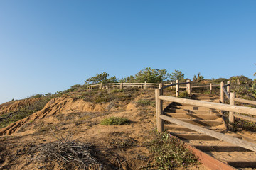 Fototapeta na wymiar Stairs and trails at Torrey Pines State Park in Southern California offers beautiful rocky coastal views of the Pacific Ocean