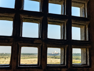 Taj Mahal behind bars - panoramic view of fields with Taj Mahal in background  from Agra Red Fort in Agra, Uttar Pradesh, India