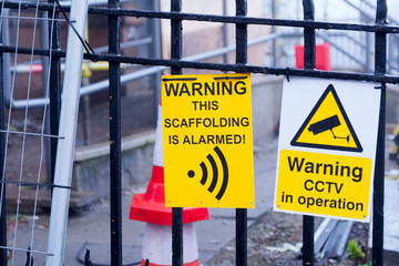 Scaffolding is alarmed warning CCTV operation sign at construction building site