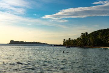 Naklejka premium Beutiful vietnamese beach on the Phu Quoc island with many palms,rocks and white sand,travel concept