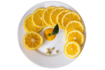 Fresh sliced lemon on a white plate, Volkamer variety, close-up, isolated