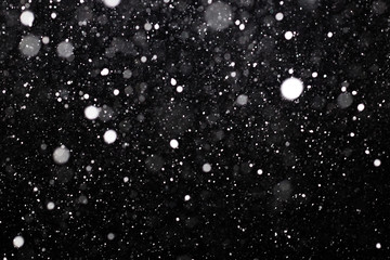 Snowfall on black background