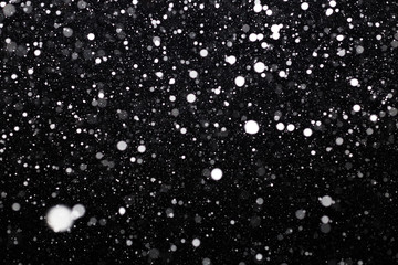 Snowfall on black background