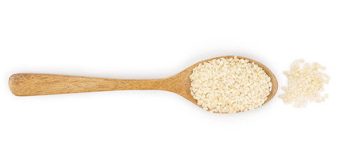 sesame seeds in a wooden spoon isolated on white background. Top view. Flat lay