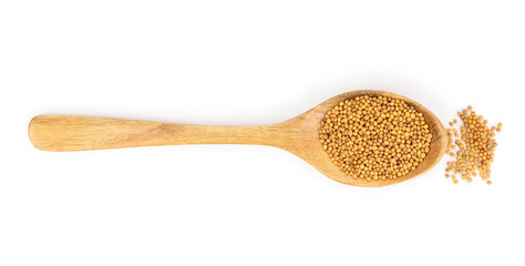 Yellow mustard seeds in wooden spoon isolated on white background, top view