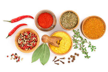 mix of spices in wooden bowl isolated on a white background. Top view. Flat lay. Set or collection