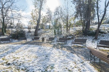 Empty wooden benches under snow. Kugulu Park, Ankara, Turkey
