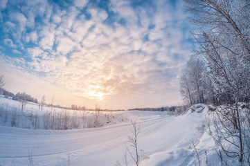 Fototapeta na wymiar beautiful landscape, winter rural road at sunset, fisheye distortion