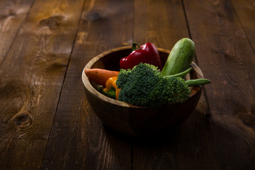 fresh vegetables in a wooden bowel on the table