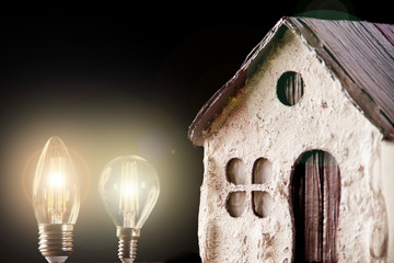 Silhouette led lamps against the background of the silhouette of the layout of the house on a black background.