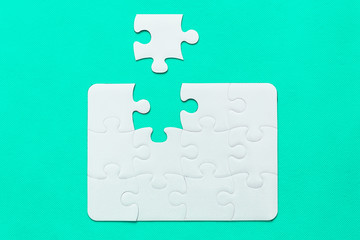 Jigsaw Puzzle with missing piece on mint background Top view