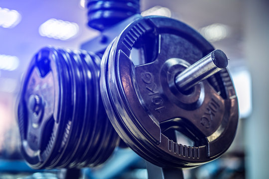 Black steel burbell disks in the gym, gym equipment concept. Close-up. Workout training and fitness gym concept.
