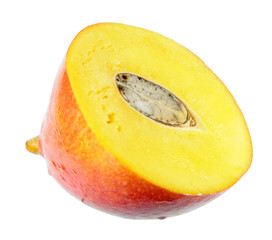 Juicy ripe yellow mango fruit cut in half across isolated on white background