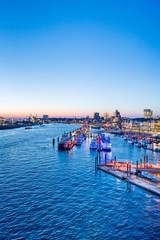 Naklejka premium Aerial view of Hamburg Harbor, Germany, at dusk. The Port of Hamburg (Hamburger Hafen) is a sea port on the river Elbe. It is Germany's largest port and the second-busiest port in Europe.