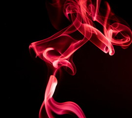 Red smoke on black background