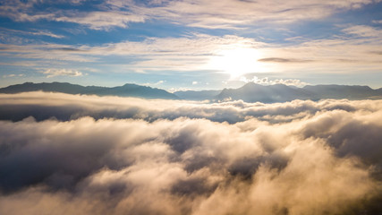 View of golden light on morning clouds in blue sky. Flight through moving cloudscape with beautiful sun rays. Use for cinema background.