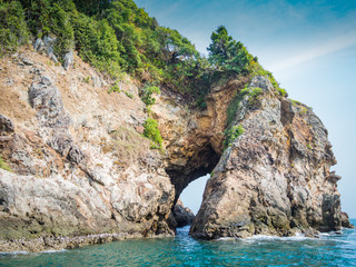 Fototapeta na wymiar Hole on a crag of an island