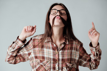 Cute young brunette girl in lumbercheck check shirt playing with hair