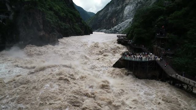Slow motion drone shot of narrow mountain canyon at impressive Tiger Leaping Gorge in China
