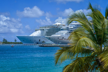 Ships dock in Nassau Bahamas on sunny day with palm tress 