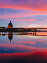 Sunset over Garonne River, with reflections of Saint-Pierre Bridge and Chapel of hôpital...