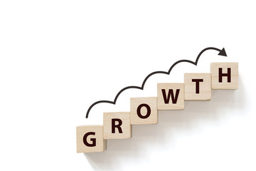 Business success growing growth increase up concept. Wooded cube block on white background with...