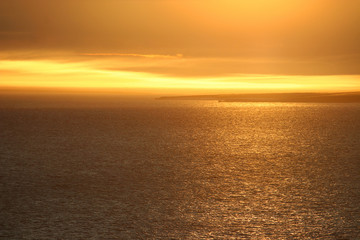 Beautiful golden sunset over the Anadyr estuary. View of the Thin Cape. Chukotka, Siberia, the Far East of Russia. Photo can be used for background.