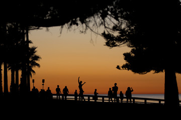 Fototapeta na wymiar Silhouette of crowd of people watching the sunset in La Jolla California