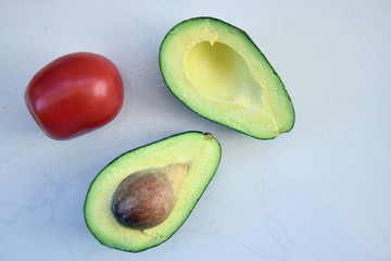 Avocado cut in half with tomato