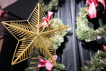 Fototapeta premium Golden Christmas star on Christmas tree.