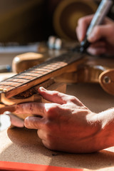 Luthier craftsman in home workshop