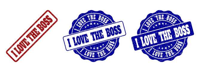 I LOVE THE BOSS grunge stamp seals in red and blue colors. Vector I LOVE THE BOSS imprints with dirty surface. Graphic elements are rounded rectangles, rosettes, circles and text captions.