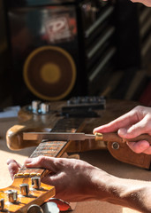 Luthier craftsman in home workshop