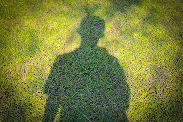 Shadow man on grass field
