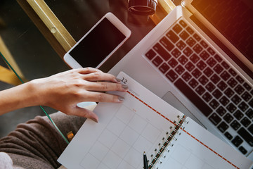 Top view of female secretary hand writing and planing conference or internal meeting.