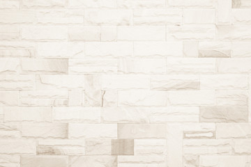 Cream colors and white brick wall art concrete or stone texture background in wallpaper limestone abstract paint to flooring and homework/Brickwork or stonework clean grid uneven interior rock old.