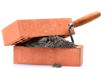 Red bricks and tools for laying on a white background