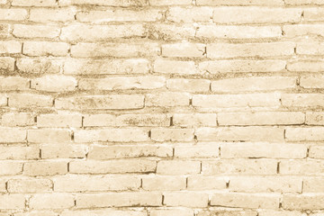 Cream colors and brown brick wall art concrete or stone texture background in wallpaper limestone abstract paint to flooring and homework/Brickwork or stonework clean grid uneven interior rock old.