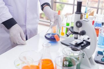Fototapeta premium Scientist in white medical gloves with accessories science in laboratory.