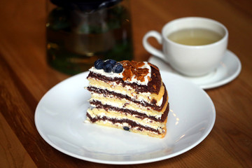 Macro photo of tasty cake with berries and tea