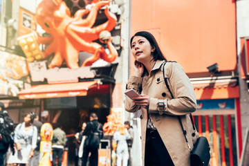 young lady traveler using online guidebook