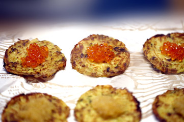 Fototapeta na wymiar Macro photo of delicious potato pancakes with caviar
