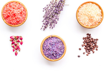 Aromas of bath salt. Coffee, rose, lavender near bowls with colorful bath salt on white background top view