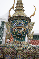 Ancient guardian giant monster god statue with scary teeth at royal template palace, signature of Thailand Travel desgination backgrounds