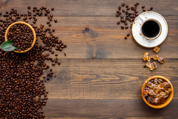 coffee background with beans and cup of americano wooden table flat lay space for text