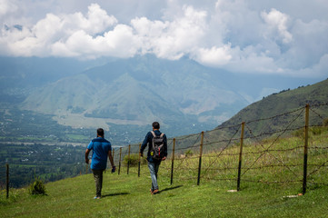 Obraz premium Two people walking down a hill in the Ganderbal district of Kashmir after trekking