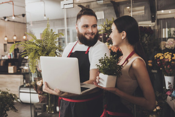 Portrait of smiling florists man and woman